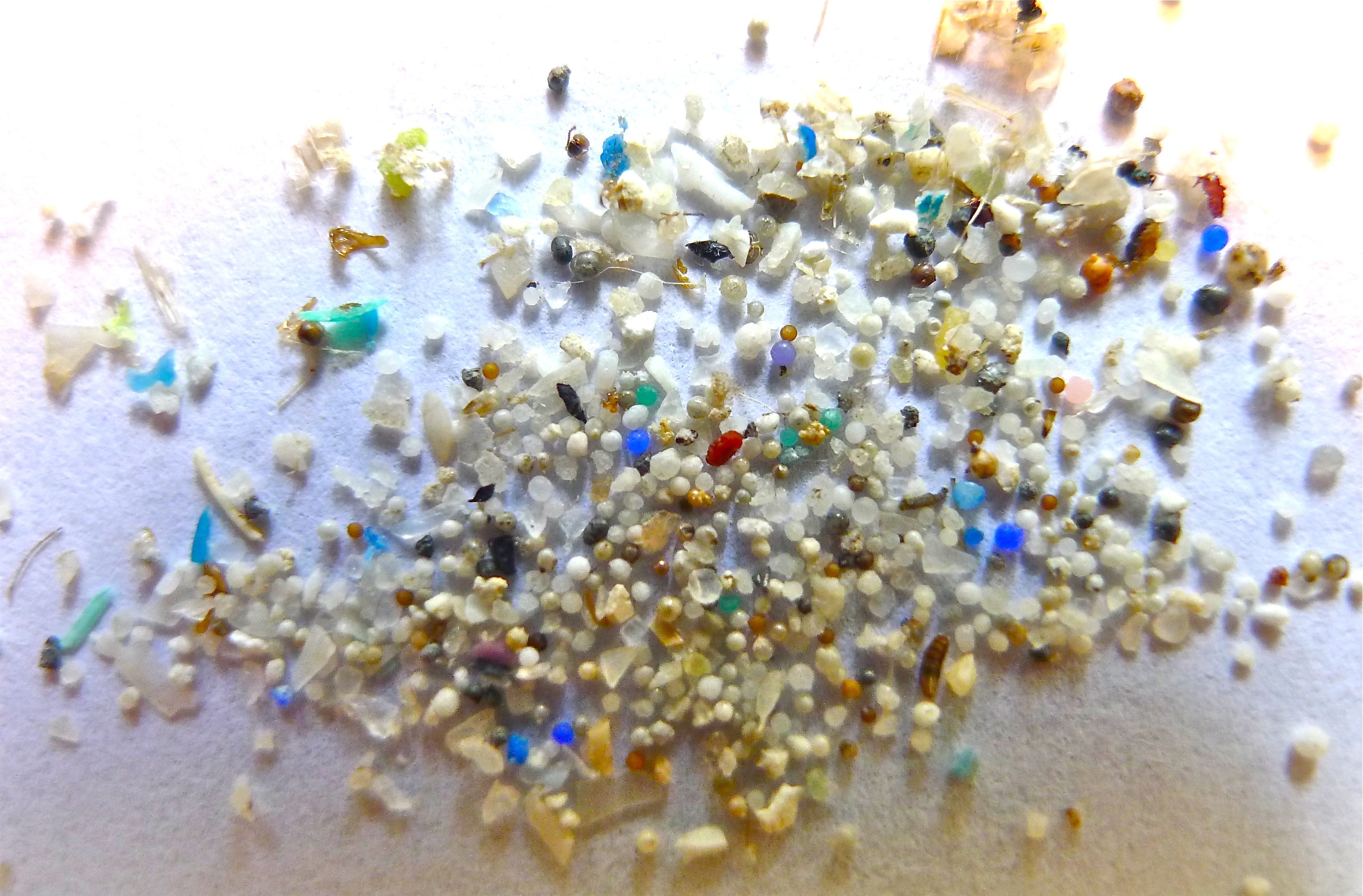 Close-up of colorful microplastic particles and pellets